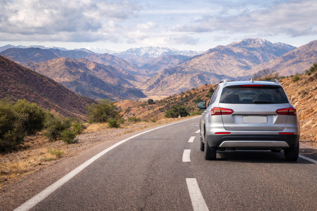 Car rental Morocco scenic drive through Atlas Mountains with modern rental vehicle